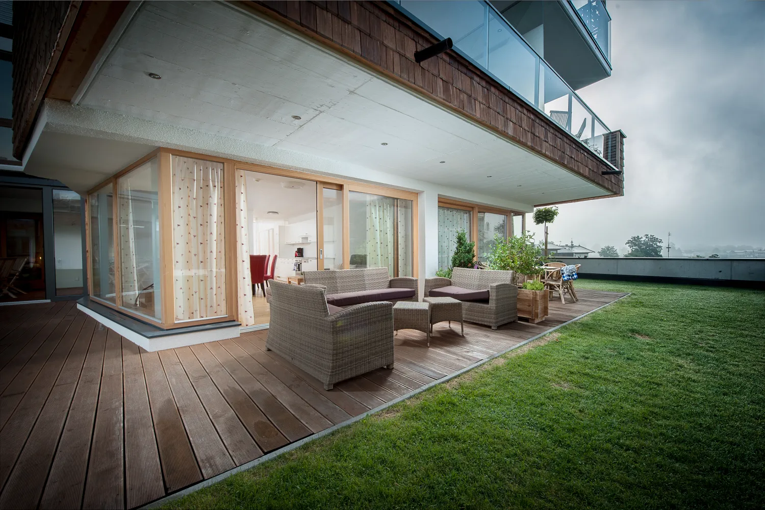 Überdachte Terrasse mit Loungemöbeln und Garten