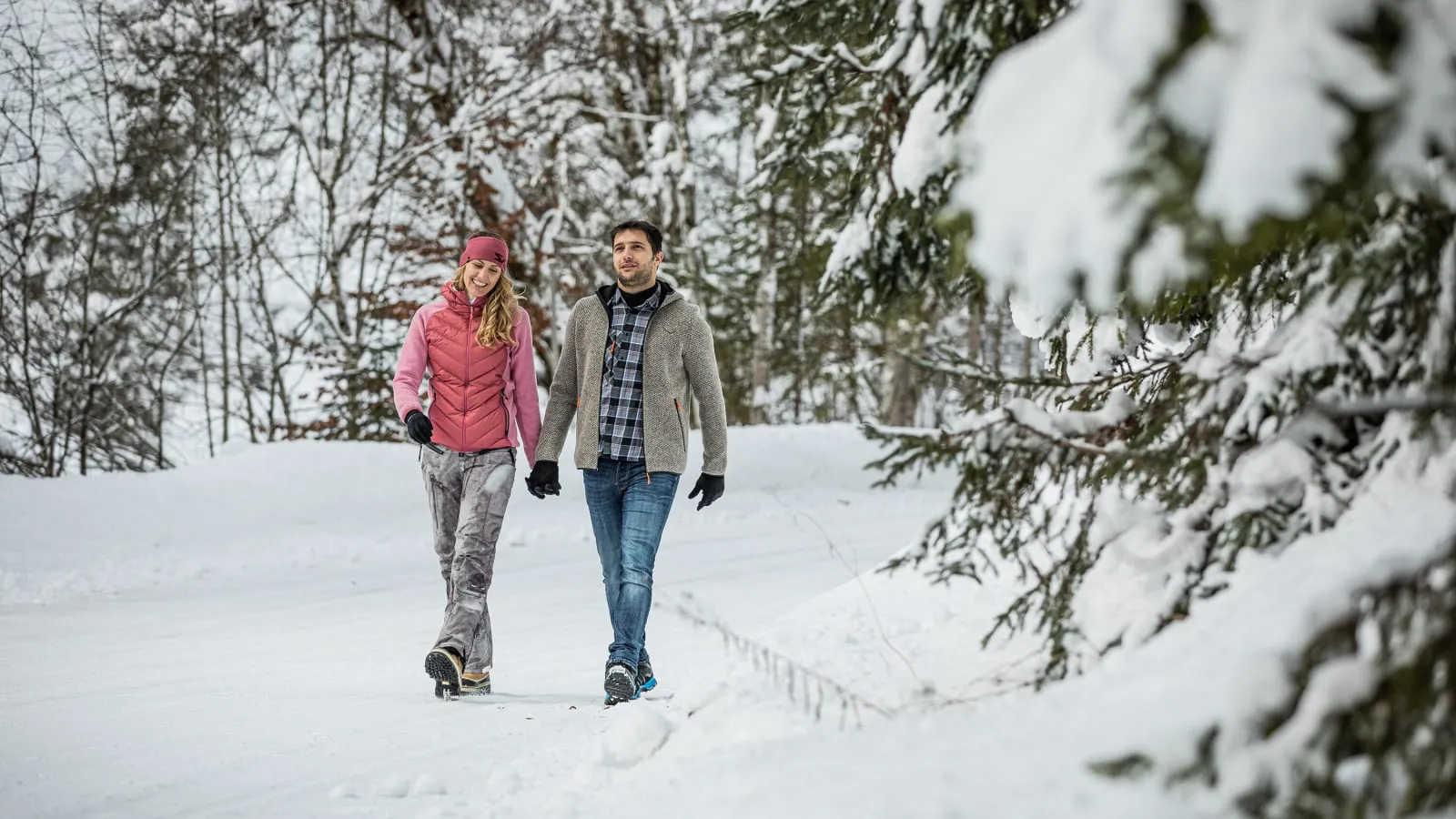 Paar beim Winterwandern im verschneiten Wald
